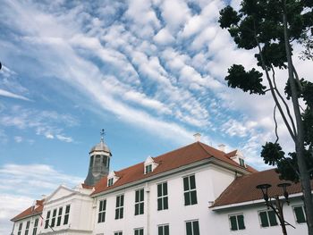 Low angle view of buildings in town against sky