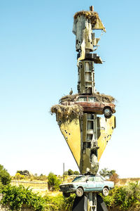 Traditional windmill on field against clear sky