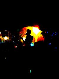 Silhouette of people at night