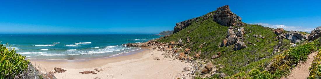 Robberg nature reserve coastline with beautiful beach and green cliffs and hills. south africa
