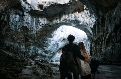 Rear view of couple standing cave