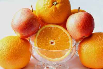 Close-up of orange fruit against white background