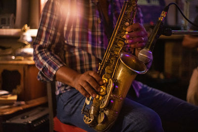 Midsection of man playing guitar