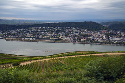 High angle view of townscape by sea against sky