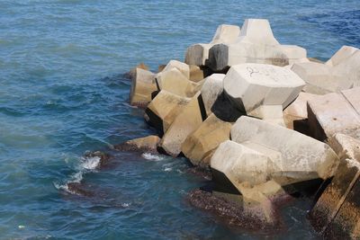 High angle view of rocks by sea