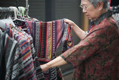Woman choosing dress in store