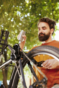 Low angle view of young woman riding bicycle