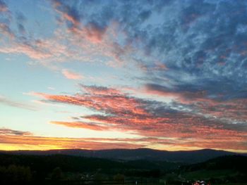 Scenic view of mountains against dramatic sky