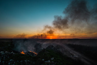 Scenic view of land against sky during sunset