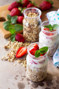 Homemade healthy breakfast with homemade baked granola, fresh strawberry and yogurt. 