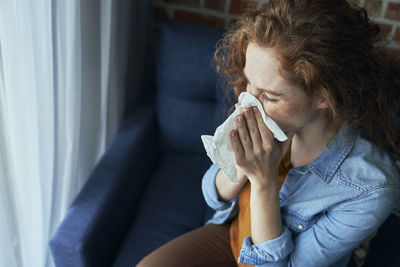 Young woman drinking milk at home