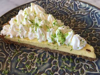 High angle view of key lime pie slice on table