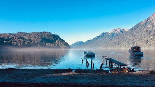 Scenic view of lake against clear blue sky