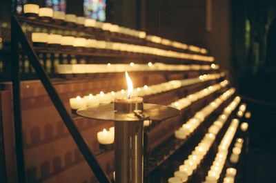 Illuminated burning candles in temple