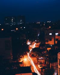 Illuminated cityscape against sky at night