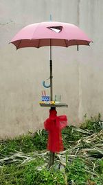 Man standing with red umbrella