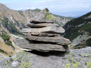 Stack of rocks in mountain against sky