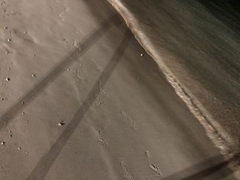 High angle view of wet sand on beach