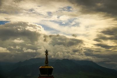 Mountain range against cloudy sky