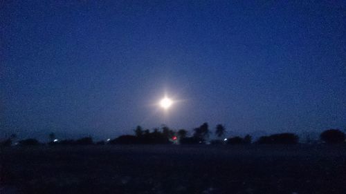 Scenic view of illuminated moon against clear sky at night