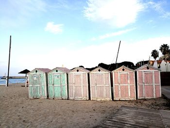 Lifeguard hut on beach against sky