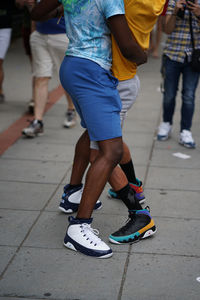 Low section of people walking on street