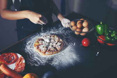 Midsection of man preparing food in kitchen at home