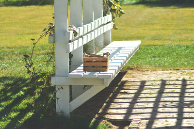View of wooden seat on grass