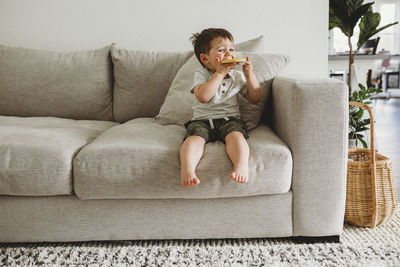 Toddler boy eating a cookie