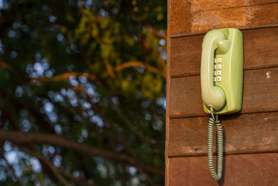 Close-up of telephone hanging on wall