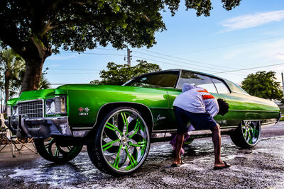 Side view of man cycling on road