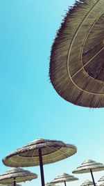 Low angle view of windmill against clear blue sky