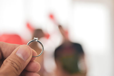 Close-up of hand holding ring