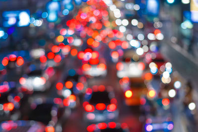 Defocused image of illuminated city at night