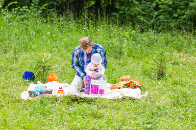 Rear view of people with toy on field