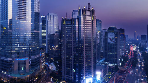 Aerial view of illuminated buildings in city at night