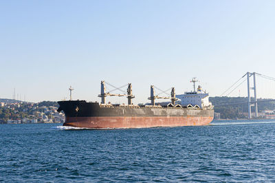 Ship in sea against clear sky