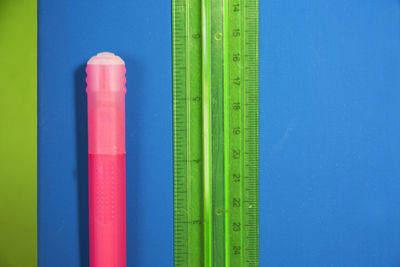 Close-up of colored pencils on table against blue background