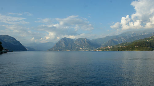 Scenic view of sea and mountains against sky