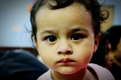 Close-up portrait of cute boy at home