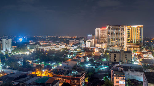 High angle view of illuminated buildings in city at night