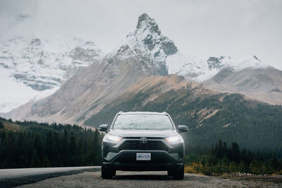 Car on snowcapped mountains during winter
