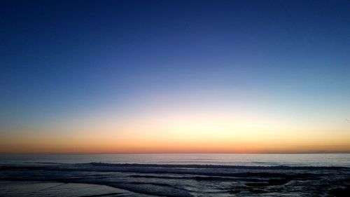 Scenic view of calm sea at sunset