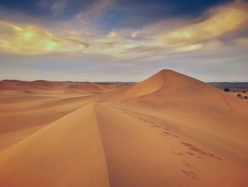 Scenic view of desert against sky during sunset