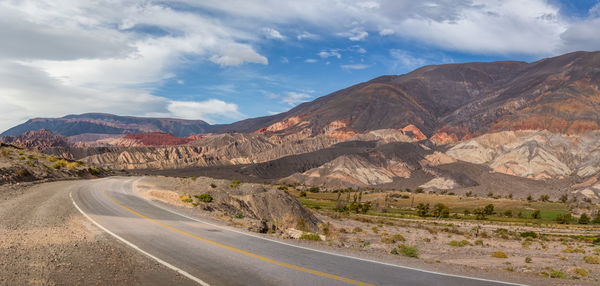 Road amidst mountains against sky