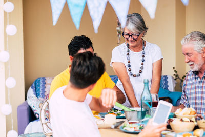 Cheerful family having food on table