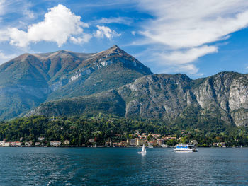 Mountains by lake como against cloudy sky