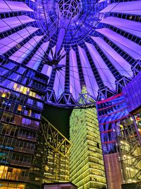 Low angle view of illuminated modern buildings in city at night