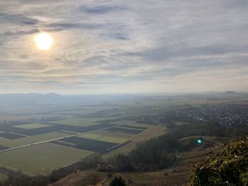 Aerial view of agricultural landscape against sky during sunset