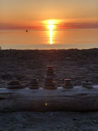 Stack of stones on beach during sunset